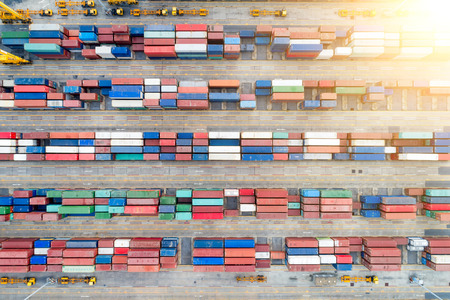 Containers yard in port congestion with ship vessels are loading and discharging operations of the...