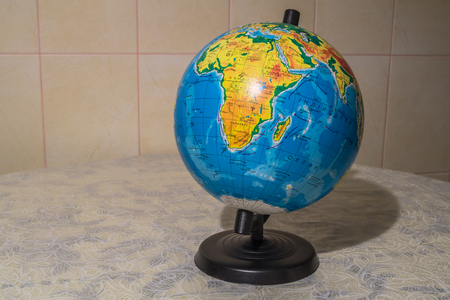 Photos plastic globe on a stand-alone on a deskの写真素材