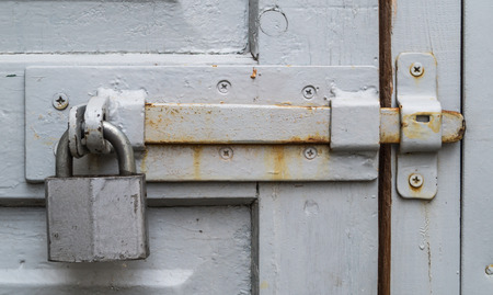 Old bolt and padlock on the door