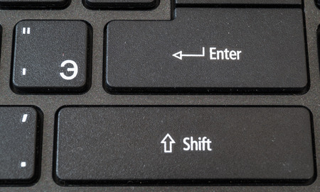 laptop keyboard in black with white lettersの写真素材