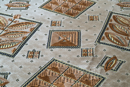 Abstract drawing on brown fabric macro shotの写真素材