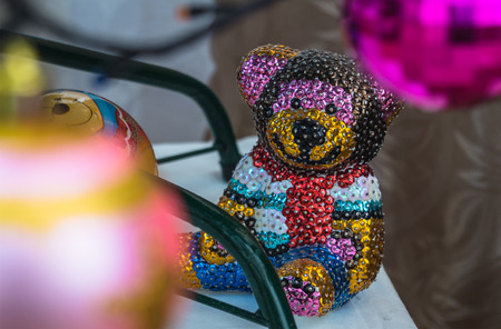 Brilliant bear sitting under the Christmas treeの写真素材