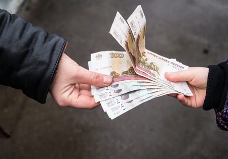 The transfer of money from hand to handの写真素材