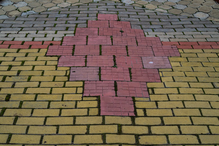 Path lined with burgundy tiles for background