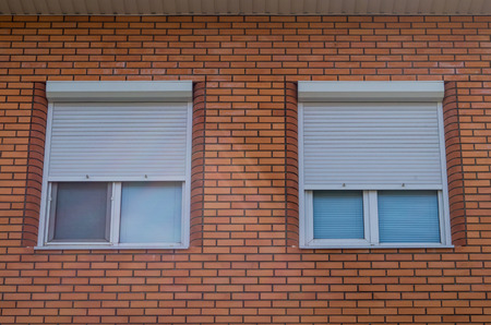 plastic window of a house from a red brick