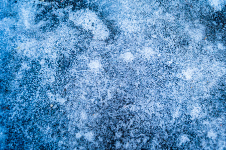 Macro shot of frozen water on the pavementの写真素材