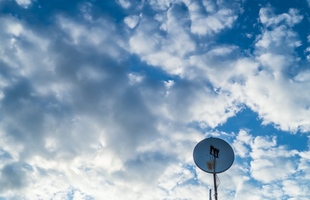 satellite dish on the background of the cloudy skyの写真素材
