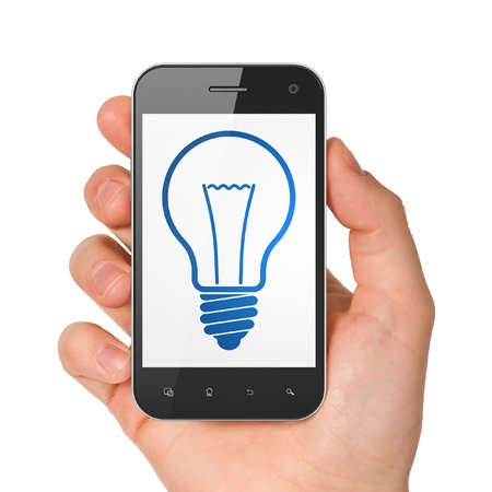 Finance concept  hand holding smartphone with Light Bulb on display  Generic mobile smart phone in hand on White background の写真素材