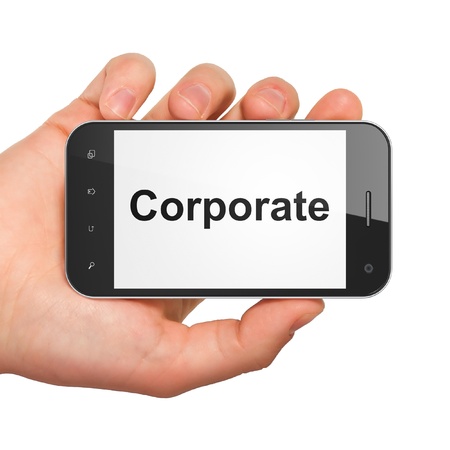 Finance concept  hand holding smartphone with word Corporate on display  Generic mobile smart phone in hand on White background の写真素材
