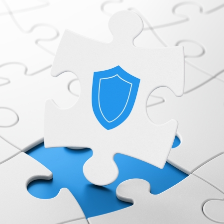 Safety concept: Shield on White puzzle pieces background, 3d renderの写真素材