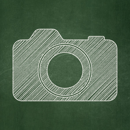 Travel concept: Photo Camera icon on Green chalkboard background, 3d renderの写真素材