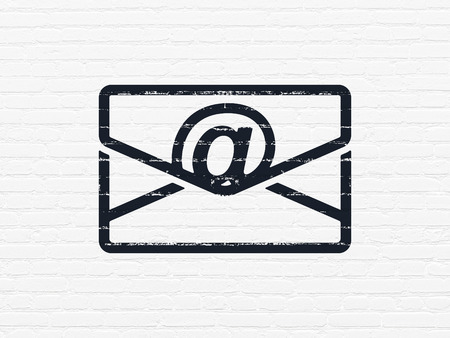 Business concept: Painted black Email icon on White Brick wall backgroundの写真素材