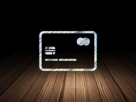 Business concept: Glowing Credit Card icon in grunge dark room with Wooden Floor, black backgroundの写真素材