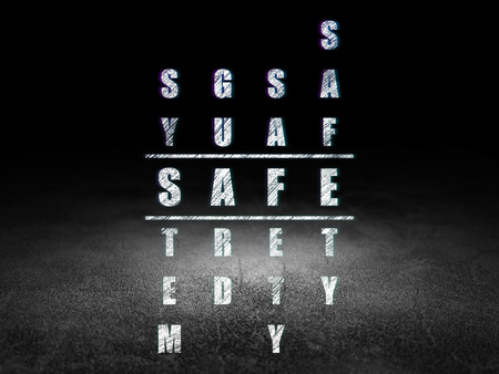 Protection concept: Glowing word Safe in solving Crossword Puzzle in grunge dark room with Dirty Floor, black backgroundの写真素材