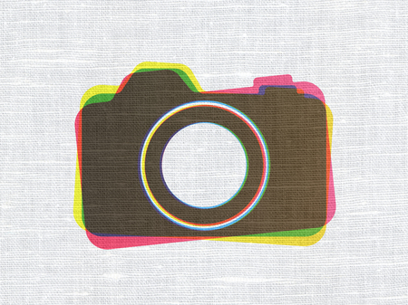 Vacation concept: CMYK Photo Camera on linen fabric texture backgroundの写真素材