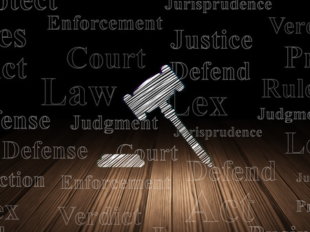 Law concept: Glowing Gavel icon in grunge dark room with Wooden Floor, black background with  Tag Cloudの写真素材
