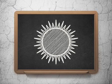 Vacation concept: Sun icon on Black chalkboard on grunge wall backgroundの写真素材