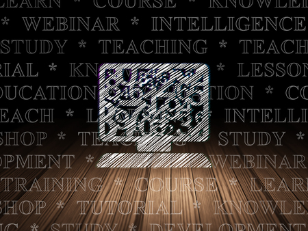 Studying concept: Glowing Computer Pc icon in grunge dark room with Wooden Floor, black background with  Tag Cloudの写真素材