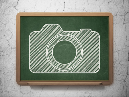 Travel concept: Photo Camera icon on Green chalkboard on grunge wall backgroundの写真素材