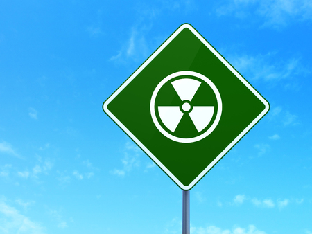 Science concept: Radiation on green road highway sign, clear blue sky background, 3d renderの写真素材