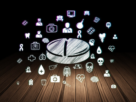 Medicine concept: Glowing Pill icon in grunge dark room with Wooden Floor, black background with  Hand Drawn Medicine Iconsの写真素材