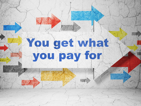 Business concept:  arrow with You get what You pay for on grunge textured concrete wall backgroundの写真素材