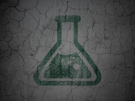 Science concept: Green Flask on grunge textured concrete wall backgroundの写真素材