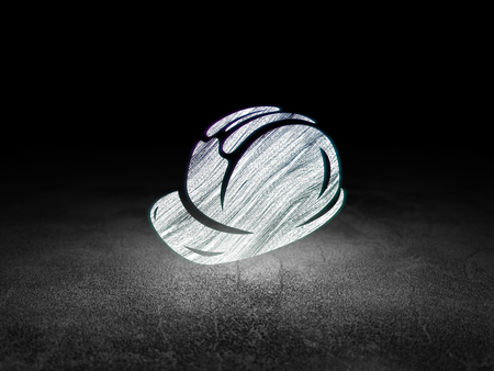 Constructing concept: Glowing Safety Helmet icon in grunge dark room with Dirty Floor, black backgroundの写真素材