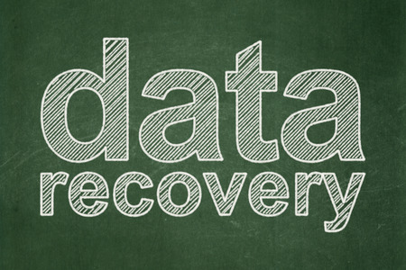 Information concept: text Data Recovery on Green chalkboard backgroundの写真素材