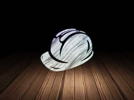 Building construction concept: Glowing Safety Helmet icon in grunge dark room with Wooden Floor, black backgroundの写真素材