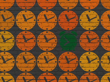 Time concept: rows of Painted orange clock icons around green alarm clock icon on Black Brick wall backgroundの写真素材