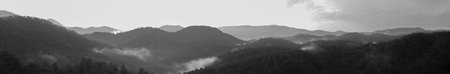 Mountain panorama with a dramatic sky background