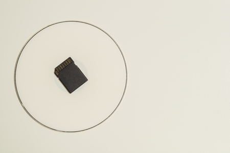 Memory card and digital disc isolated on white background. sd card and cd macro. copy spaceの写真素材