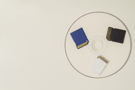 Memory card and digital disc isolated on white background. sd card and cd macro. copy space