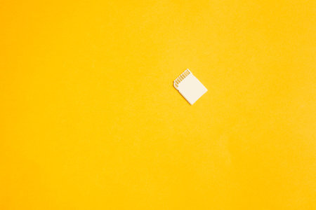 Memory card isolated on yellow background. sd card and copy spaceの写真素材