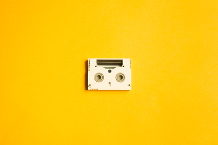 Digital video cassette on yellow background. mini cassette. copy spaceの写真素材