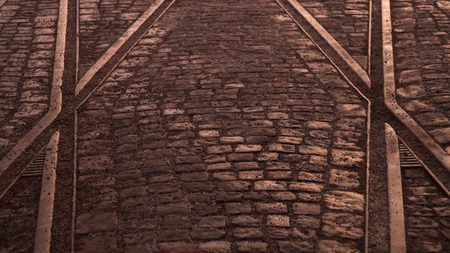 Crossing of tram rails on stone pavement backgroundの写真素材