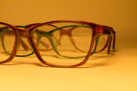 Rimmed eyeglasses closeup on a white background abstract view