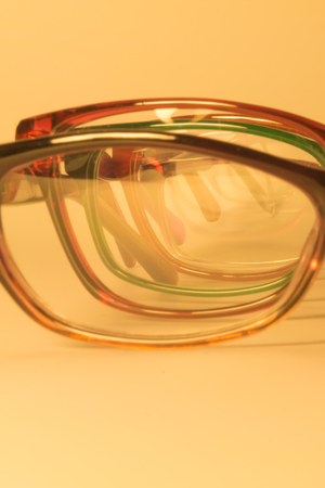 Rimmed eyeglasses closeup on a white background abstract viewの写真素材
