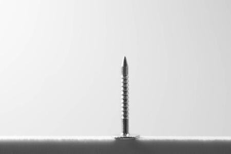 Metal nail isolated on white backgroundの写真素材