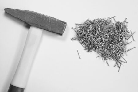 Hammer and metal nails isolated on white backgroundの写真素材