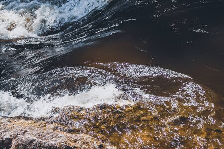 Water stream with foam. falling river water. waterfall flow. water backgroundの写真素材