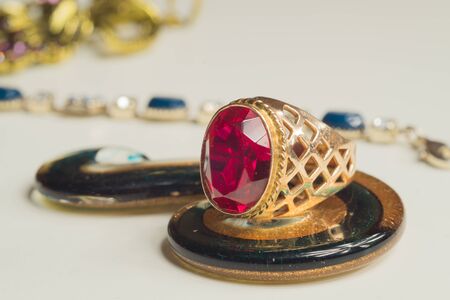 Golden ring with the ruby isolated on white. jewelry backgroundの写真素材