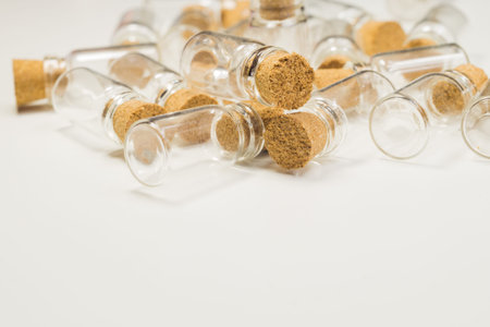 Empty little bottles with cork stopper isolated on white. glass vessels. transparent containers. test tubes. copy spaceの写真素材