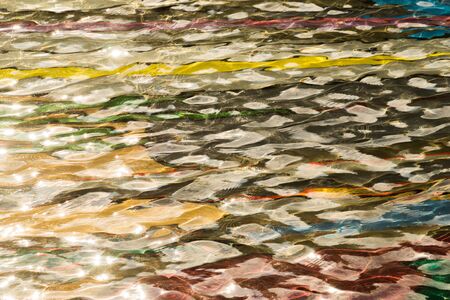 colorful pool water abstract background. colored bottom of the pool with rippled waterの写真素材