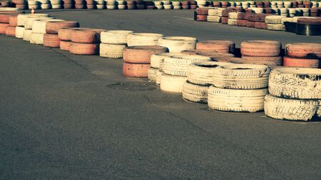 Race track safety barrier. asphalt racing track with red and white tires. colorful tires stack. karting race trackの写真素材