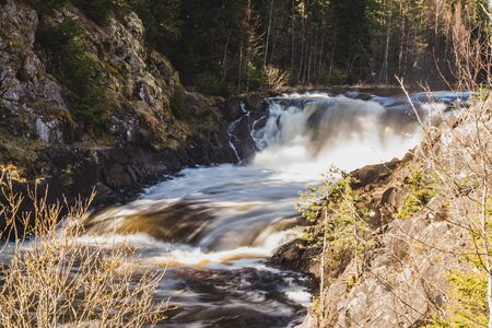 Waterfall nature background. rushing stream water. rocky flowing riverの写真素材