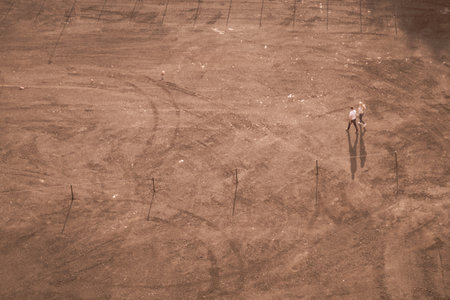 Couple walking on the sand in sunny day. aerial view. ground with tracks and footprints. view from...