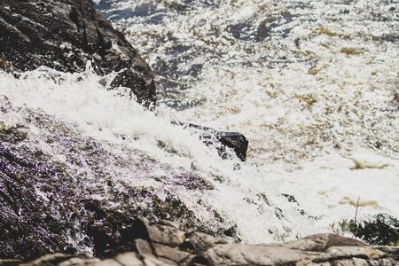 Waterfall nature background. rushing stream water. rocky flowing riverの写真素材