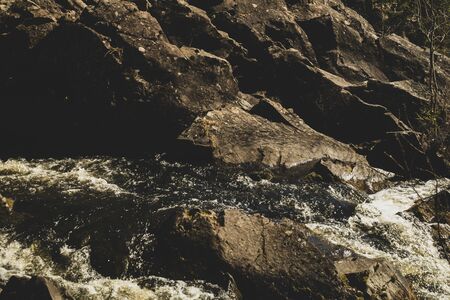 Waterfall nature background. rushing stream water. rocky flowing riverの写真素材
